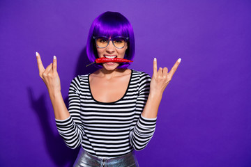 Portrait of funny teenager with bangs hold chilly pepper show rocker sign wear eyewear eyeglasses...