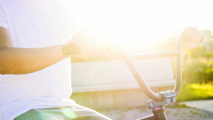 CLOSE UP Details of bmx bike equipment, extreme biker placing hands on handlebar grips