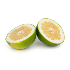 Fresh green grapefruit / pomelo half cut into two equal parts with a juicy yellow pulp. Isolated on white background. Side view.