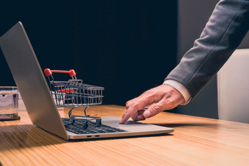 AAsian businessman using laptop computer enjoying Online Shopping Down Shopping Cart  Website on...