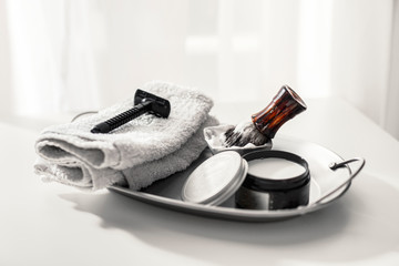 Shaving accessories on a clean background with morning light