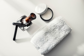 Shaving accessories on a clean background with morning light