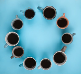 Coffee in the different cups on the blue background. Flatlay, cheerful day concept with copy space