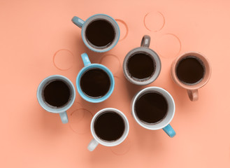 Coffee in the different cups on the beige background. Flatlay, cheerful day concept