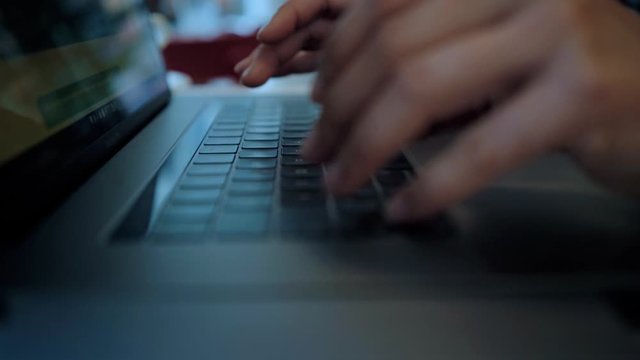 Super closeup macro shot of black keyboard surface of modern laptop and touchpad. Female hands type information or data. Concept women coding professional or big data analysis