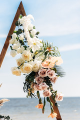White and pink roses and greens on the wedding arch