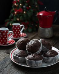 Chocolate muffins on dark wooden background. Shallow depth of field.