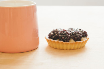 Tartlets with cream and blackberries, selective focus