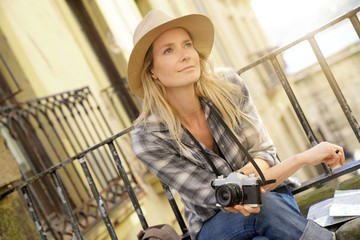 Fototapeta premium Beautiful blond woman photographer in European city