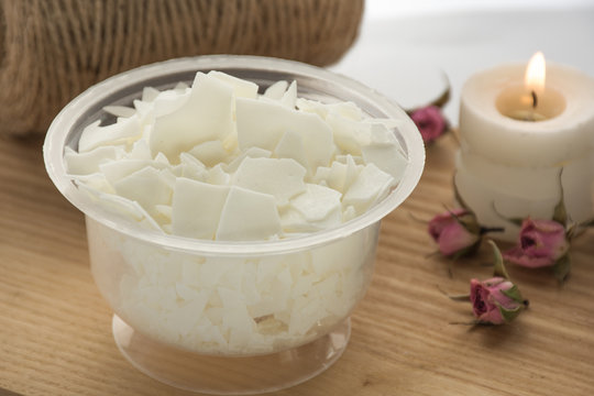Close up of soy wax. Candle making from soy wax  - ingredients for handmade candles on white background. Natural decor. Ecological candles. Front view