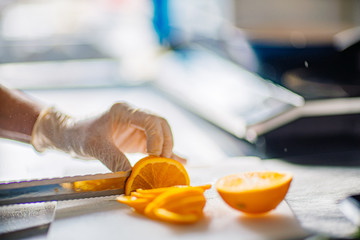 cutting an orange in the kitchen