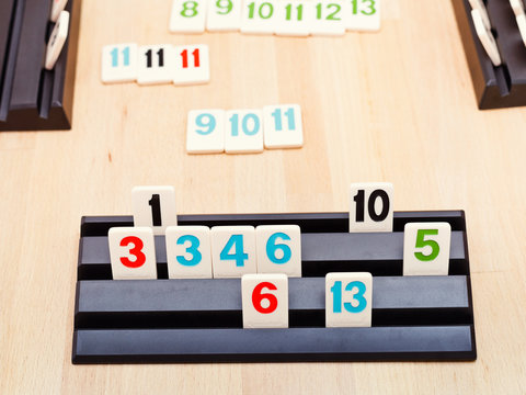 MOSCOW, RUSSIA - MARCH 17, 2014: playing rack of Rummikub board game. Rummikub was invented by Ephraim Hertzano in the early 1930s.