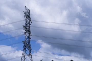 Electrical tower station wiring power with cloudy and blue sky background, High voltage station post