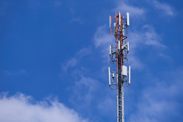 Telecommunication telephone signal transmission tower with beautiful blue sky and cloudy background