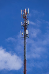 Telecommunication telephone signal transmission tower with beautiful blue sky and cloudy background