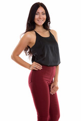 Studio shot of young happy businesswoman smiling while posing