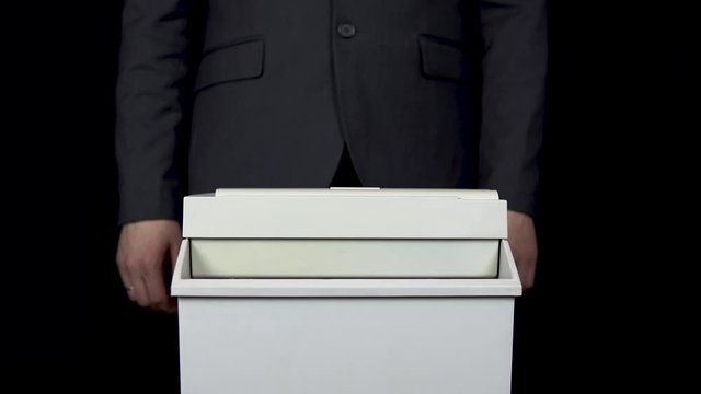Schroeder destroys one hundred euro bill. Businessman in a suit thrusts money into a paper shredder