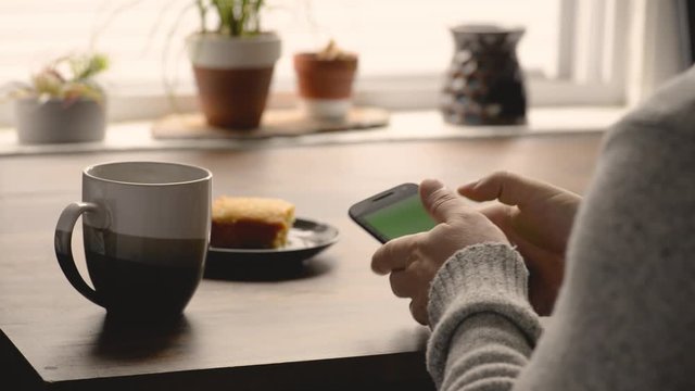 Man using cell phone at a cafe