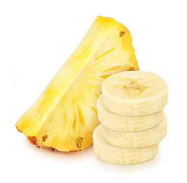 Composite image with heap of banana slices with the pineapple slice behind isolated on a white background.