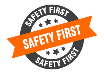 Obraz premium safety first sign. safety first orange-black round ribbon sticker