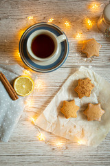 Christmas snack with tea,star-shaped cakes and garland