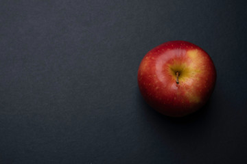 Fototapeta na wymiar Red apple on dark background, copy space.