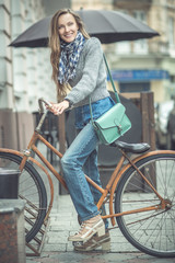 young woman with bicycle in the city