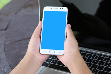 Woman hand holding smartphone with blank screen, Communication technology concept