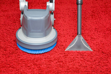 Professionally vacuum cleaner spray nozzle and disc machine on red shaggy carpet. General or...