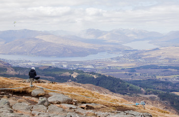 Woman sitting on the top of mountain, Nevis range, Fort William Scotland highland