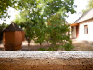 .image of wooden table in front of abstract blurred background of