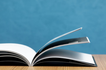 Front view open book on wooden table