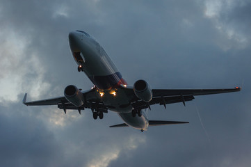 Silhouette of a passenger airliner in the sky during sunset. Airplane in the sky.