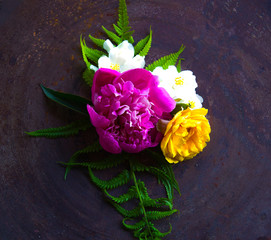 Festive flower composition on the rusty metal surface. Overhead view