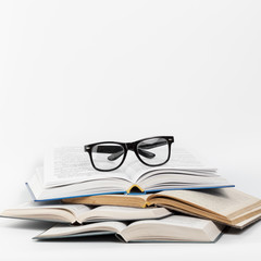 Front view open books with glasses