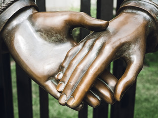 part of a bronze sculpture - hand in hand, close-up