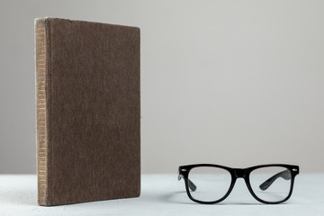 Front view standing book with glasses