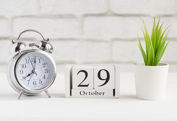 October 29 on a wooden calendar next to the alarm clock, the date of the autumn month.The concept...