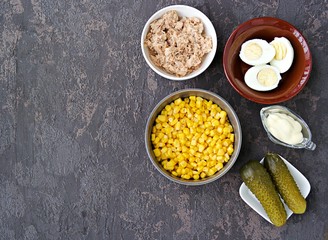 Ingredients for cooking salad with tuna and corn on a brown concrete background. Tuna Salad Recipes. Top view, copy space.