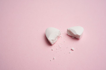 White pills on pink background