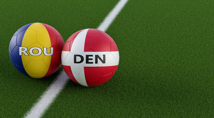 Romania vs. Denmark Soccer Match - Soccer balls in Romania and Denmark national colors on a soccer field. Copy space on the right side - 3D Rendering