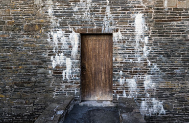 Close up on closed and locked wooden door of medieval Irish castle