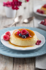 Caramel custard pudding with mint and caramel syrup on grey  background. Flan dessert made of eggs