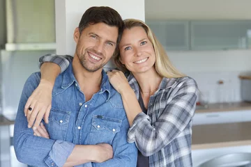 Fotobehang Portrait of cheerful middle-aged couple at home © goodluz