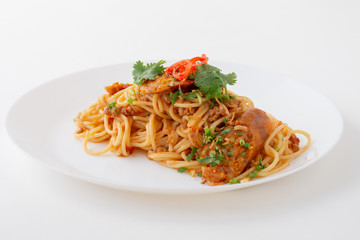 Spicy Spaghetti with Thai sausage on wood table.