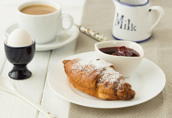 Homemade croissant served with black coffee or americano. Delicious breakfast with fresh croissant and coffee