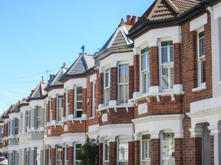 Obraz premium Row of typical British red brick terraced houses