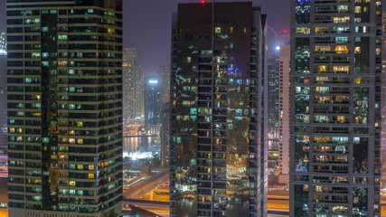 Fototapeta na wymiar Residential and office buildings in Jumeirah lake towers district night timelapse in Dubai
