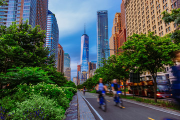 Hudson River Greenway and cyclists with One WTC view in New York City