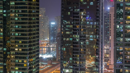 Fototapeta na wymiar Residential and office buildings in Jumeirah lake towers district night timelapse in Dubai